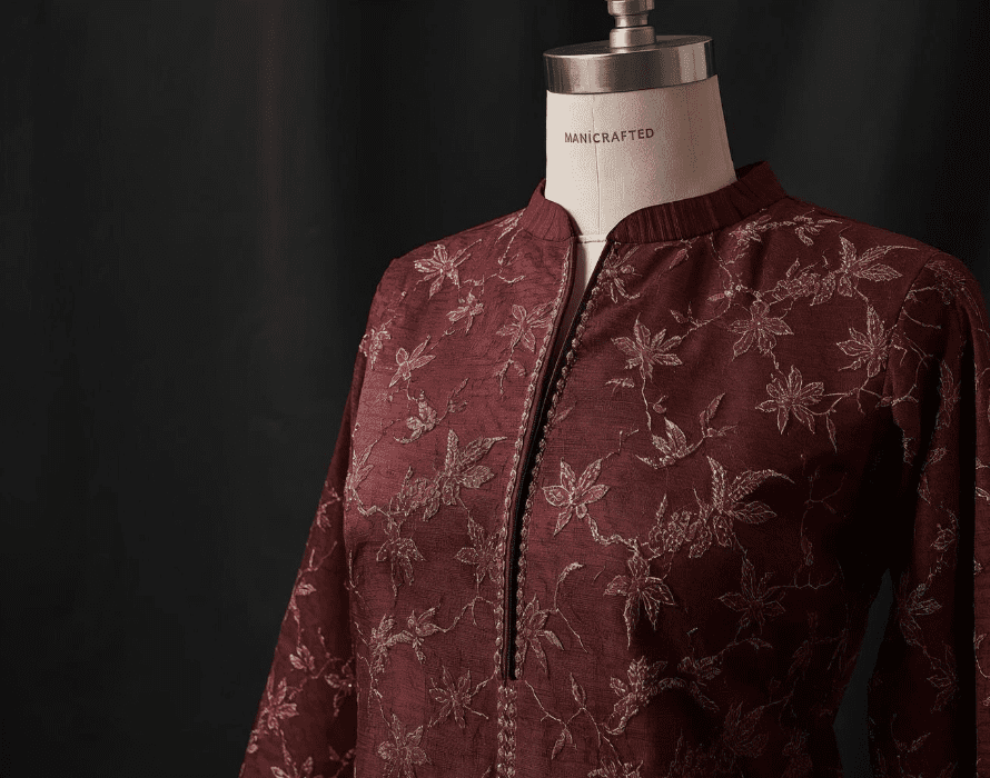 Handcrafted embroidered maroon kurti displayed on a mannequin with fine threadwork – ManiCrafted Apparel.
