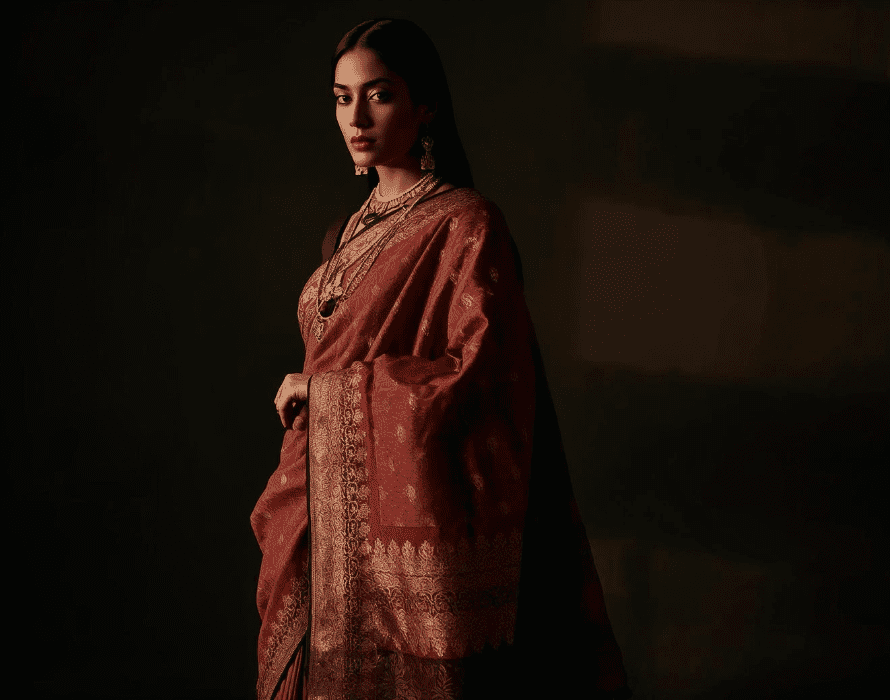 Model wearing a handcrafted Indian handloom saree in premium maroon textile – ManiCrafted Apparel.